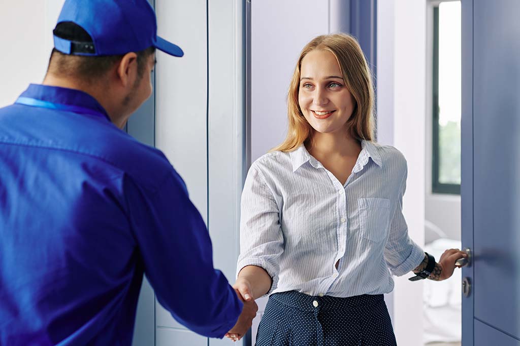 Young woman entering a door