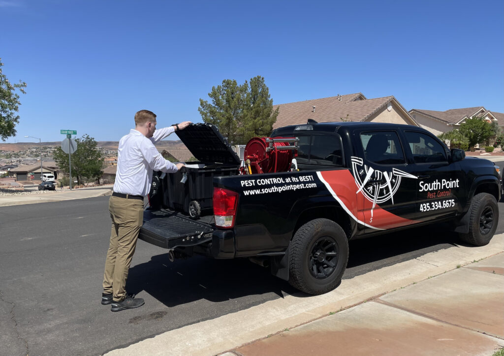 South Point Pest employee getting supplies out of truck.