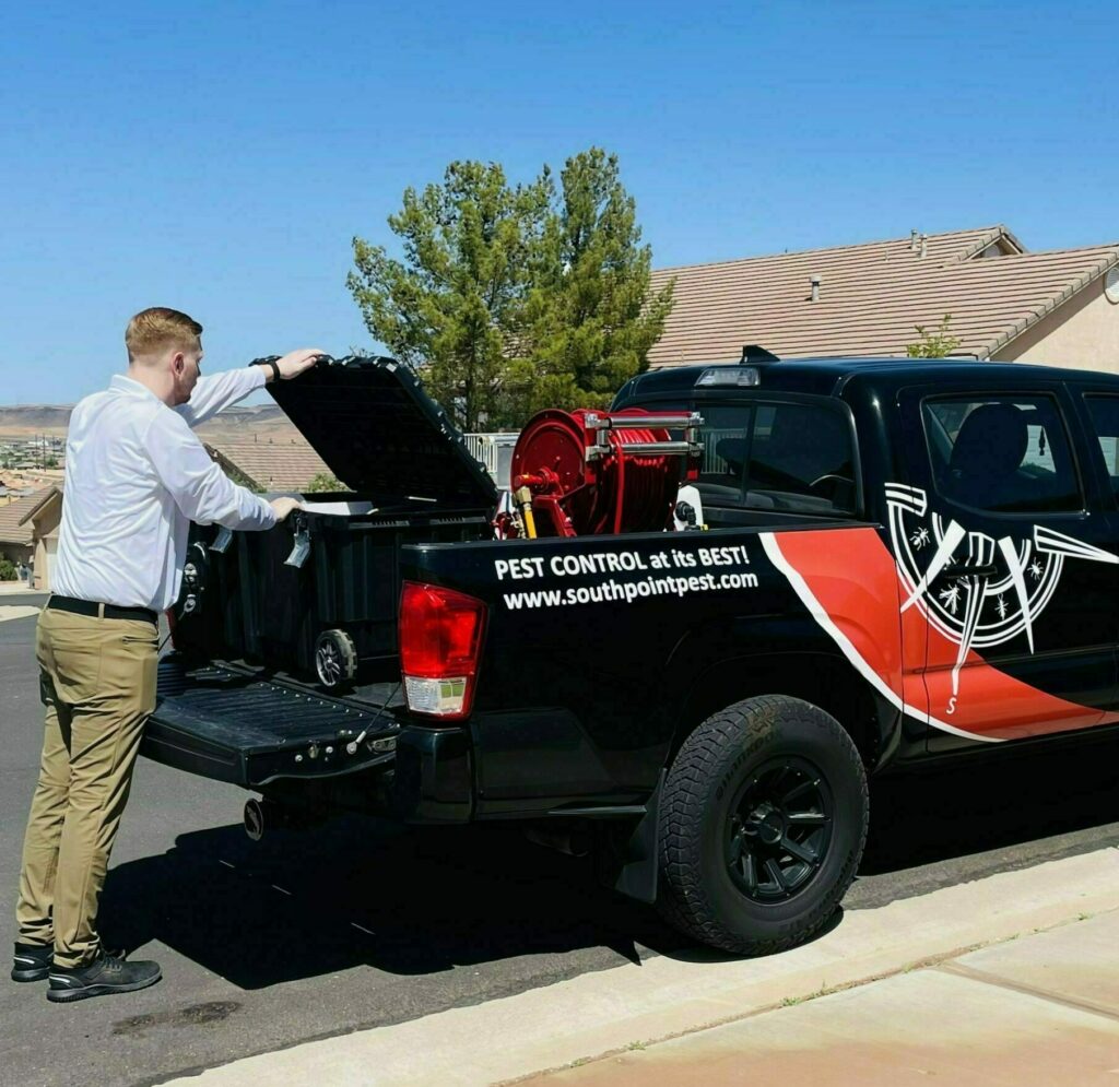 Picture of employee in outfit next to company truck